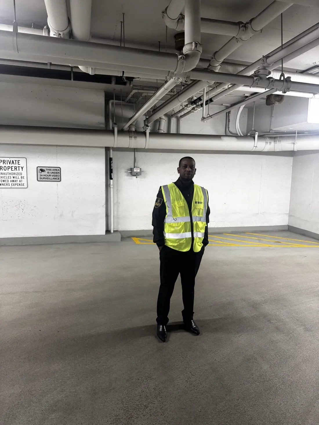Guard Tower Security guard in hi-vis patrolling an underground parkade
