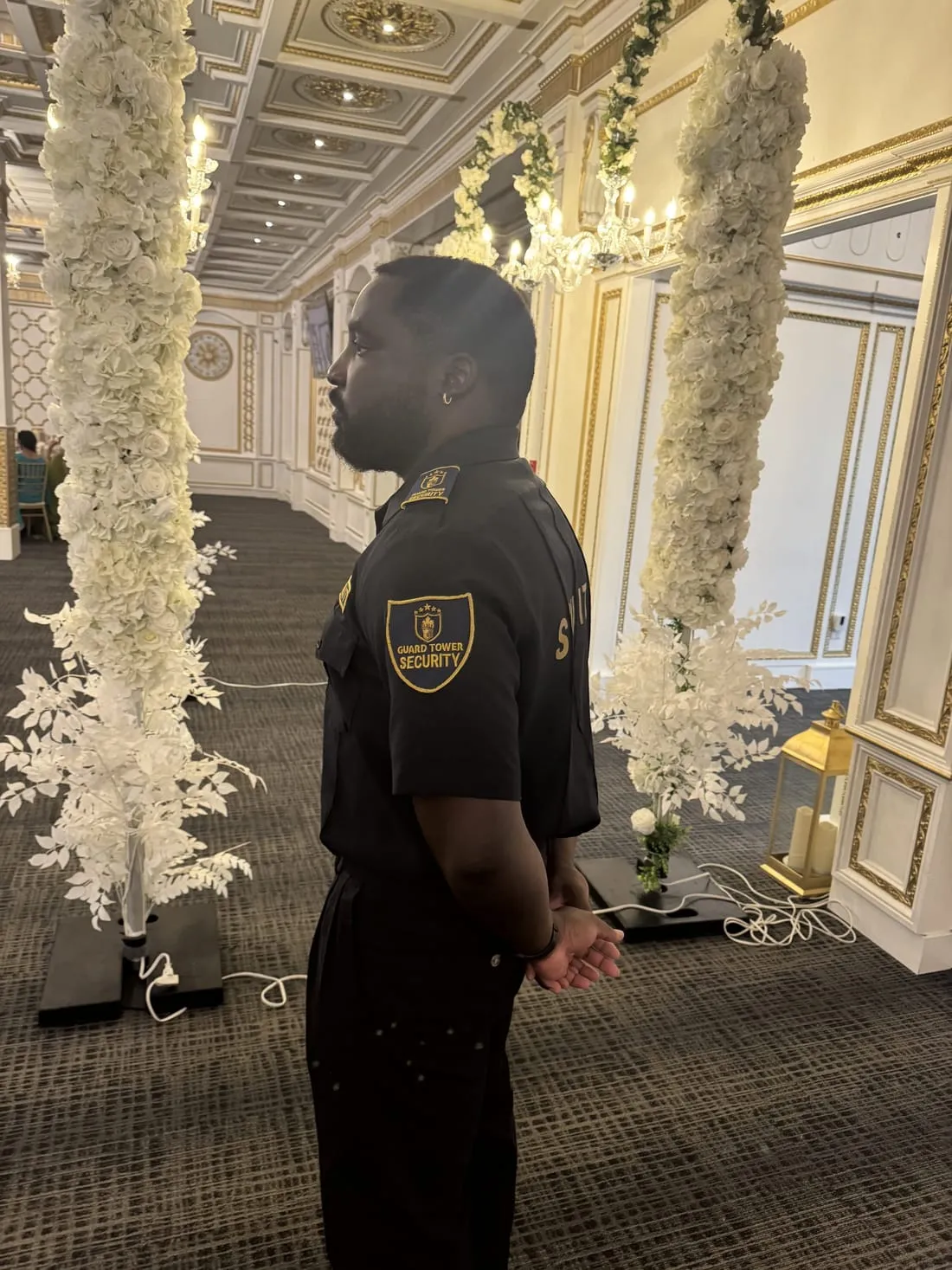Guard Tower Security guard on duty at a wedding venue with floral decor
