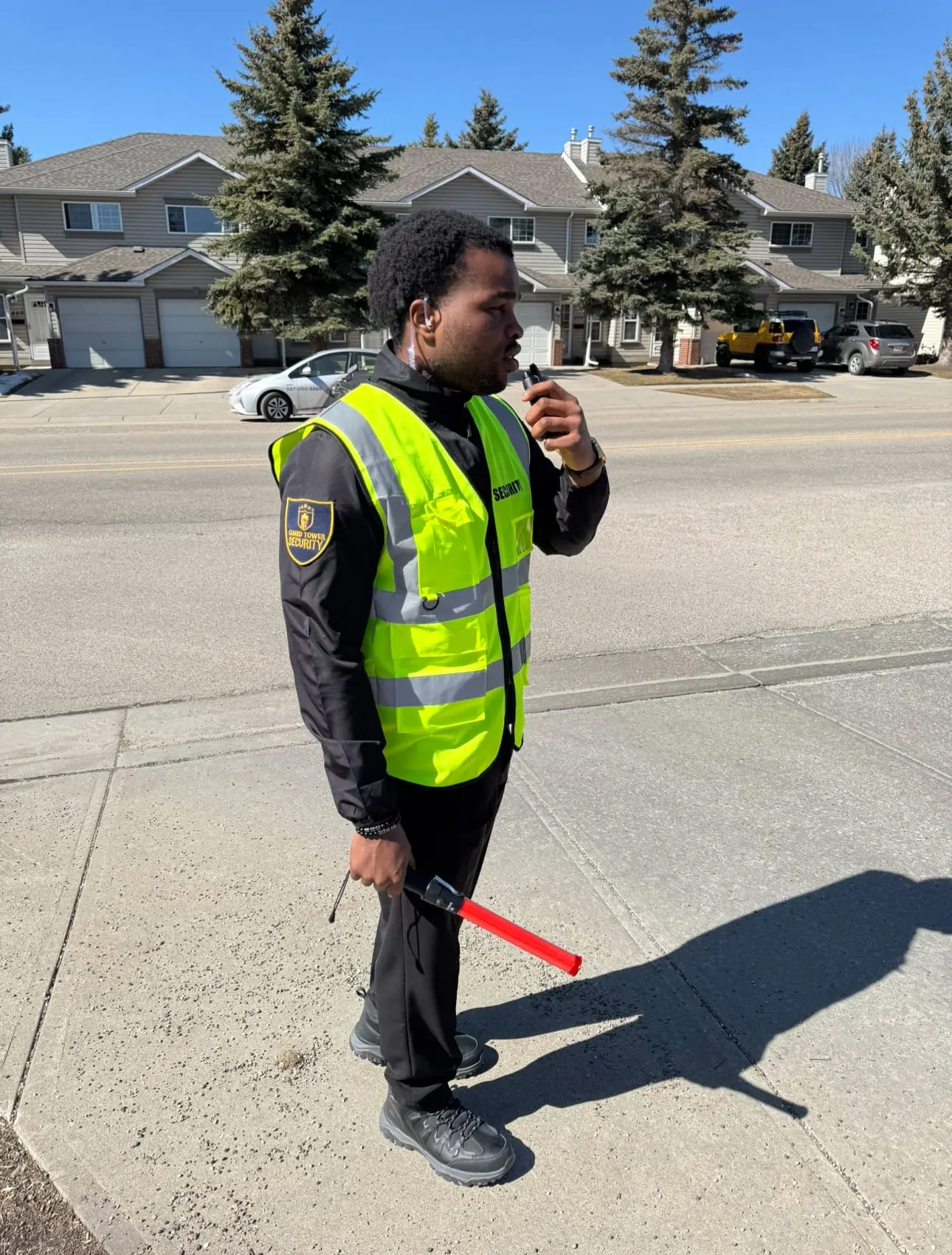 Guard Tower Security patrol guard with radio and traffic wand on community patrol