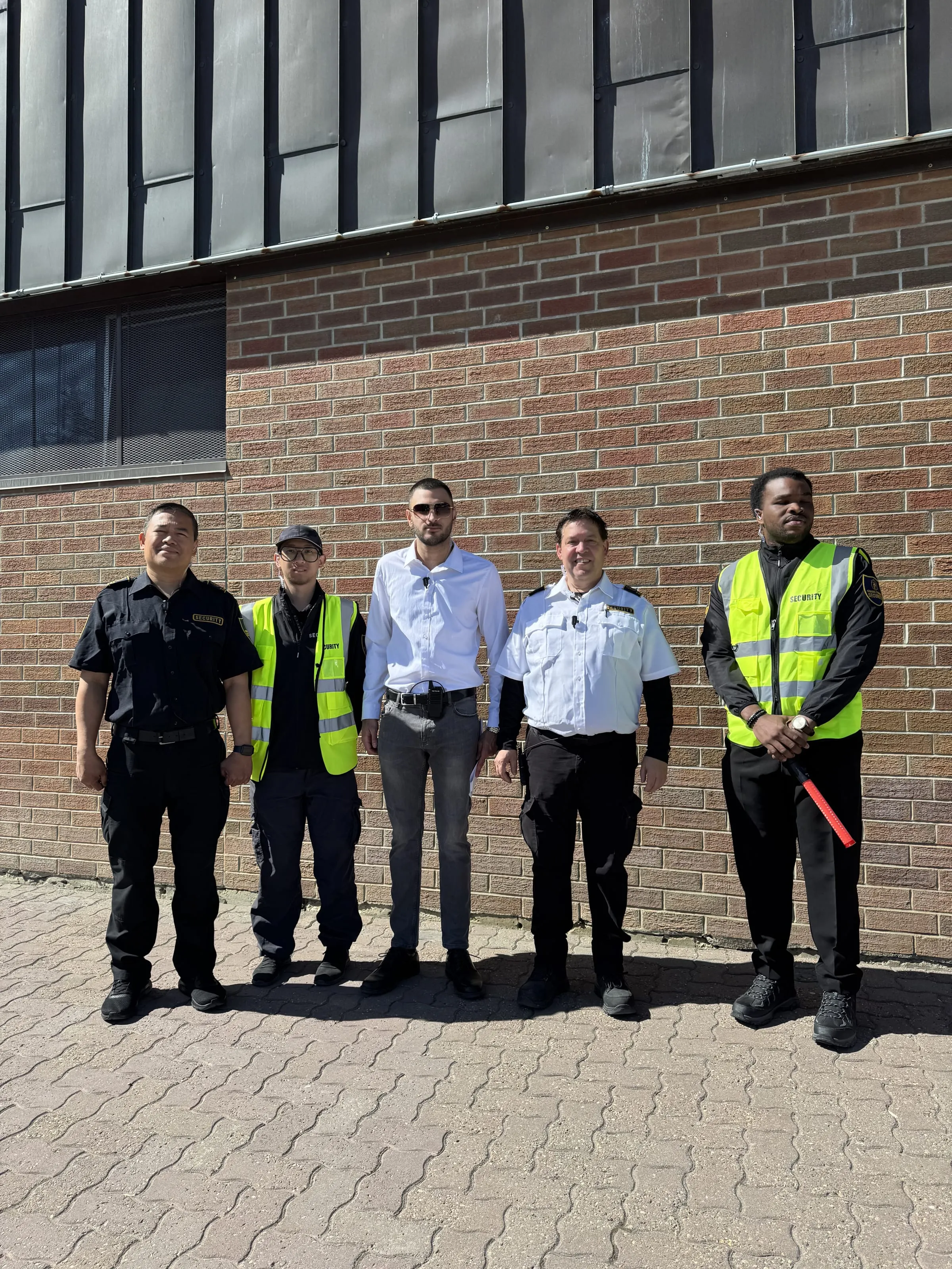 The Guard Tower Security team in front of a brick building in Calgary
