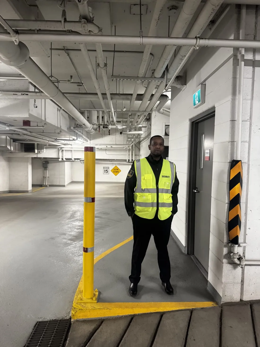 Guard Tower Security guard in hi-vis controlling access in an underground parkade